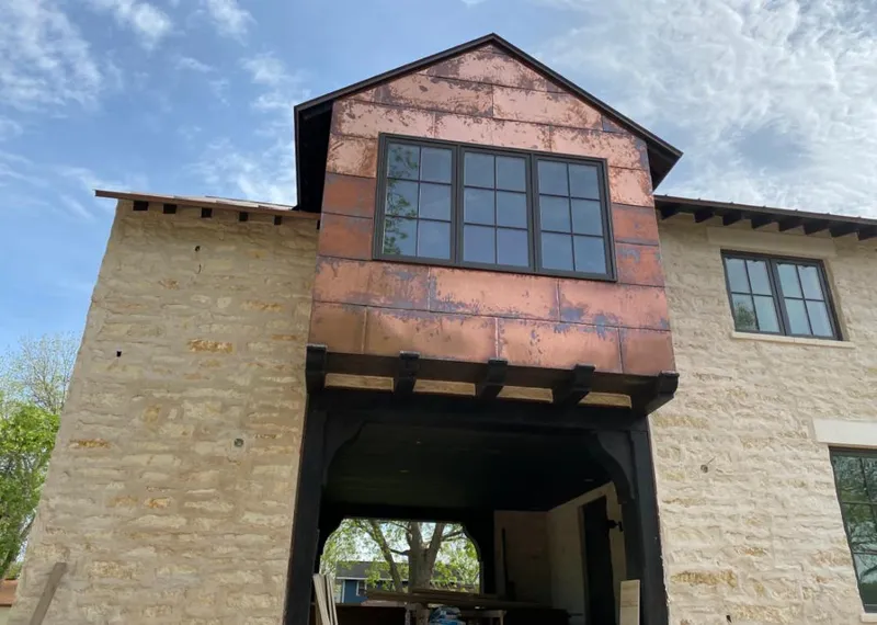 Copper metal panel facade on a stone building for Skylight Installation in Grantsville